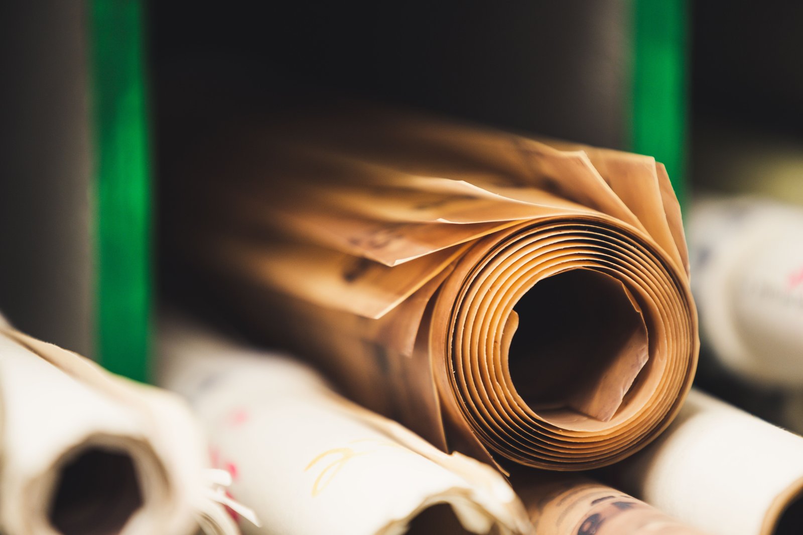 Real rolls of brown paper stacked on a shelf